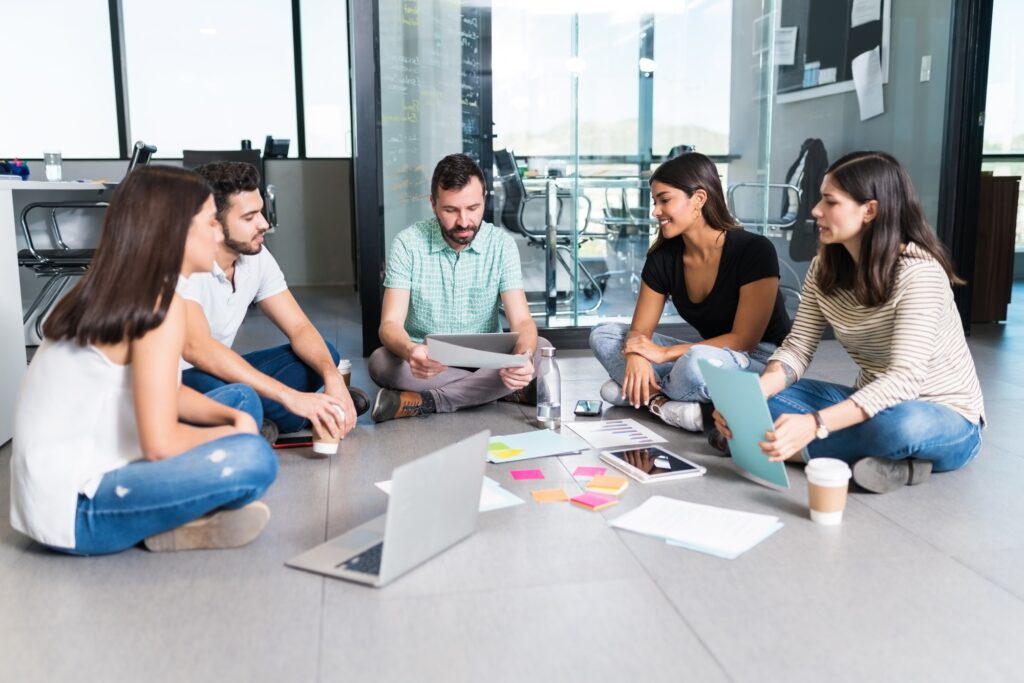 Leader Planning With Coworkers At Coworking Workplace