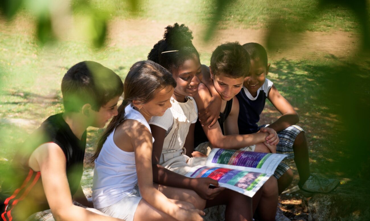 Children And Education Kids And Girls Reading Book In Park