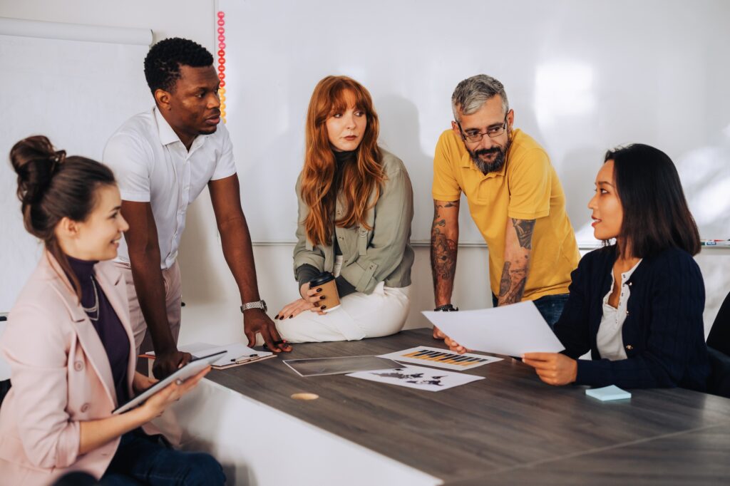 A diverse inclusive team is having briefing at boardroom.