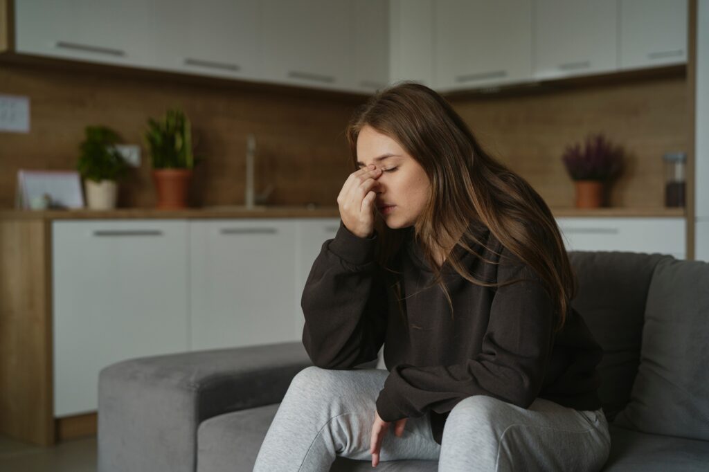 Caucasian woman with pain of nasal sinus at home