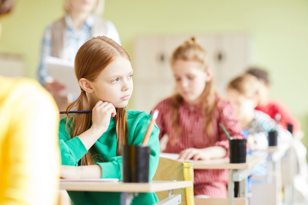 Sad student girl in classroom