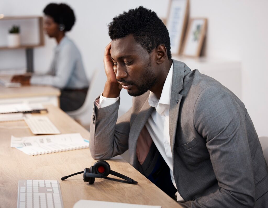 Tired, sleeping and overworked while working late in a call center or telemarketing agency. Stress,