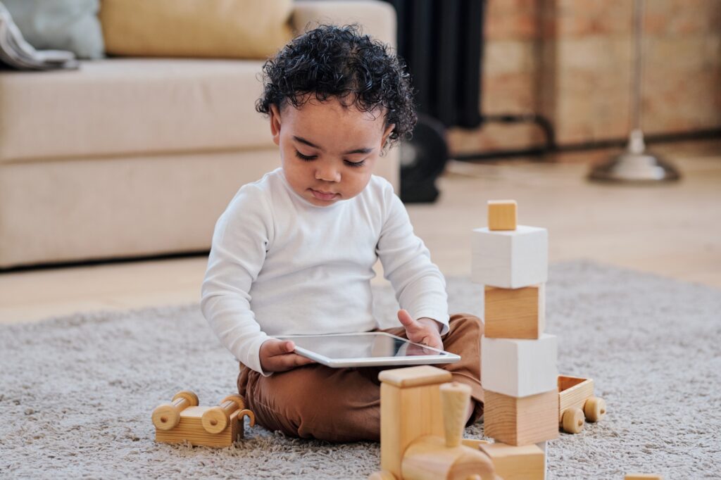 Curious toddler boy with tablet