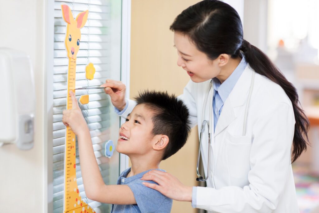Doctor measuring boy's height