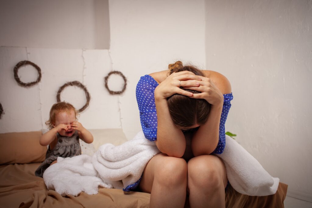 Mom is tired of the baby, wants to rest and sleep. The child screams, hysterical. The woman is tired