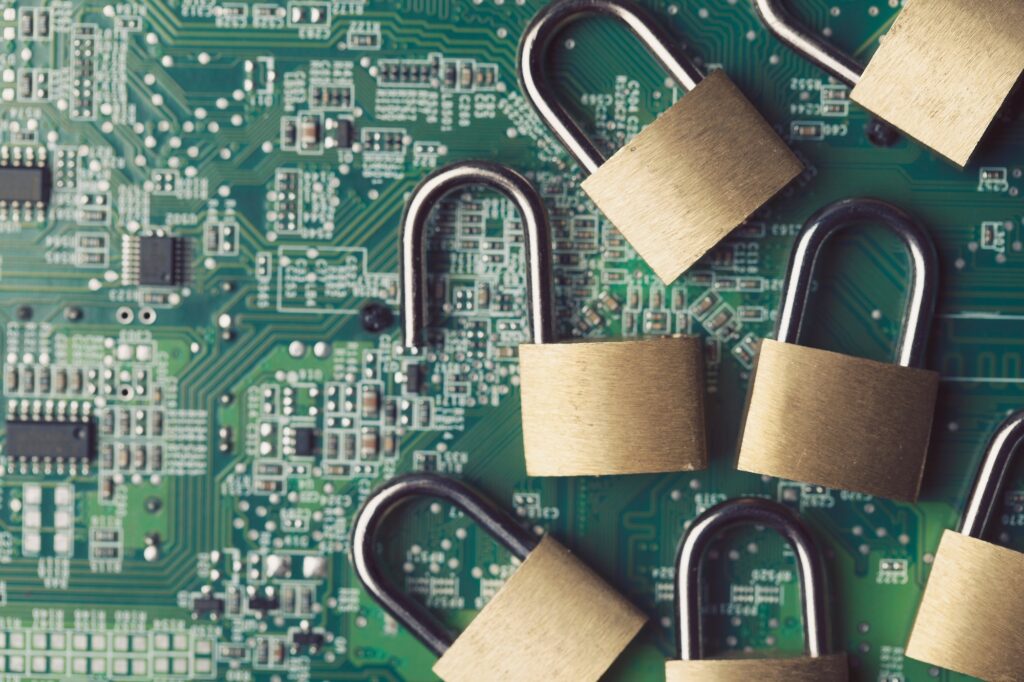 Technology security. Padlocks on a computer circuit board