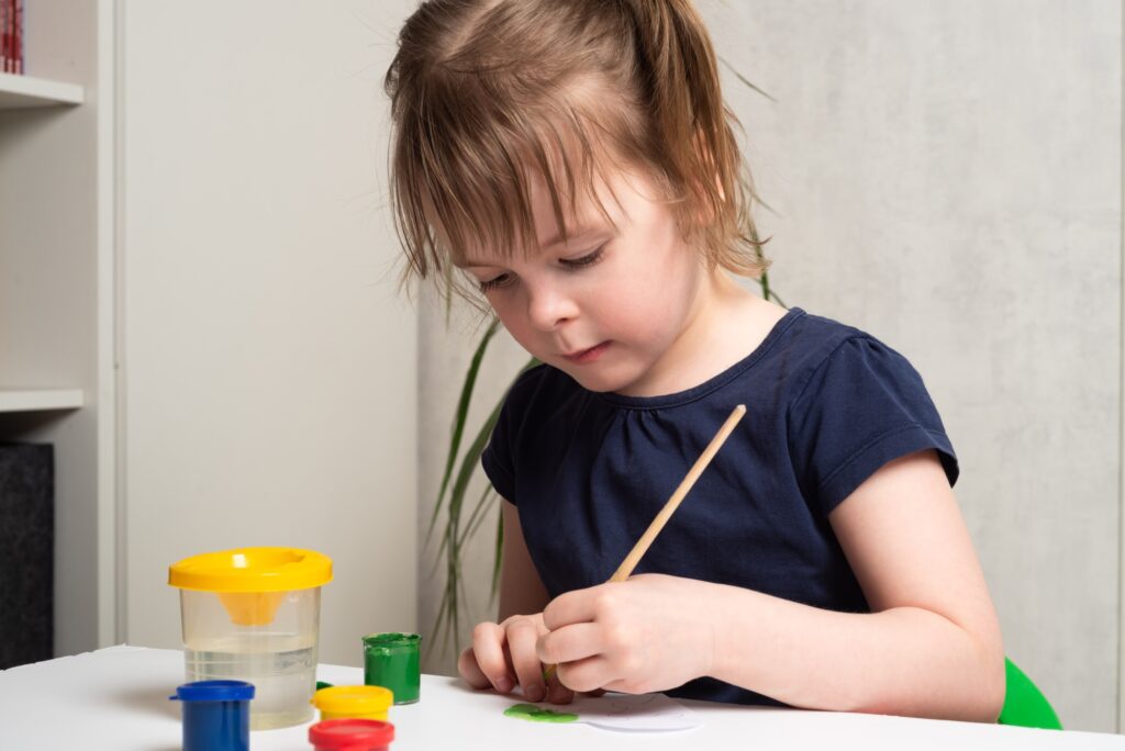 Children coloring hearts for World Autism Awareness Day