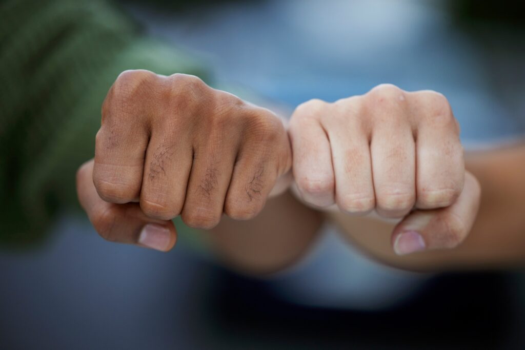 Protest, fist and people in solidarity for justice, human rights and democracy on blurred backgroun