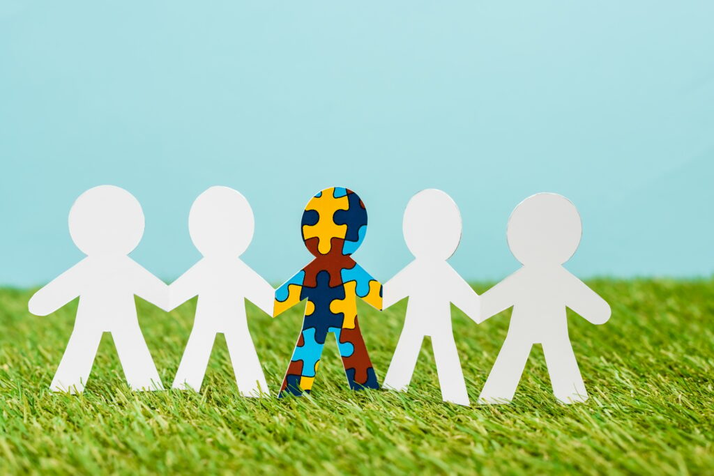 Special kid with autism among another on blue and green background